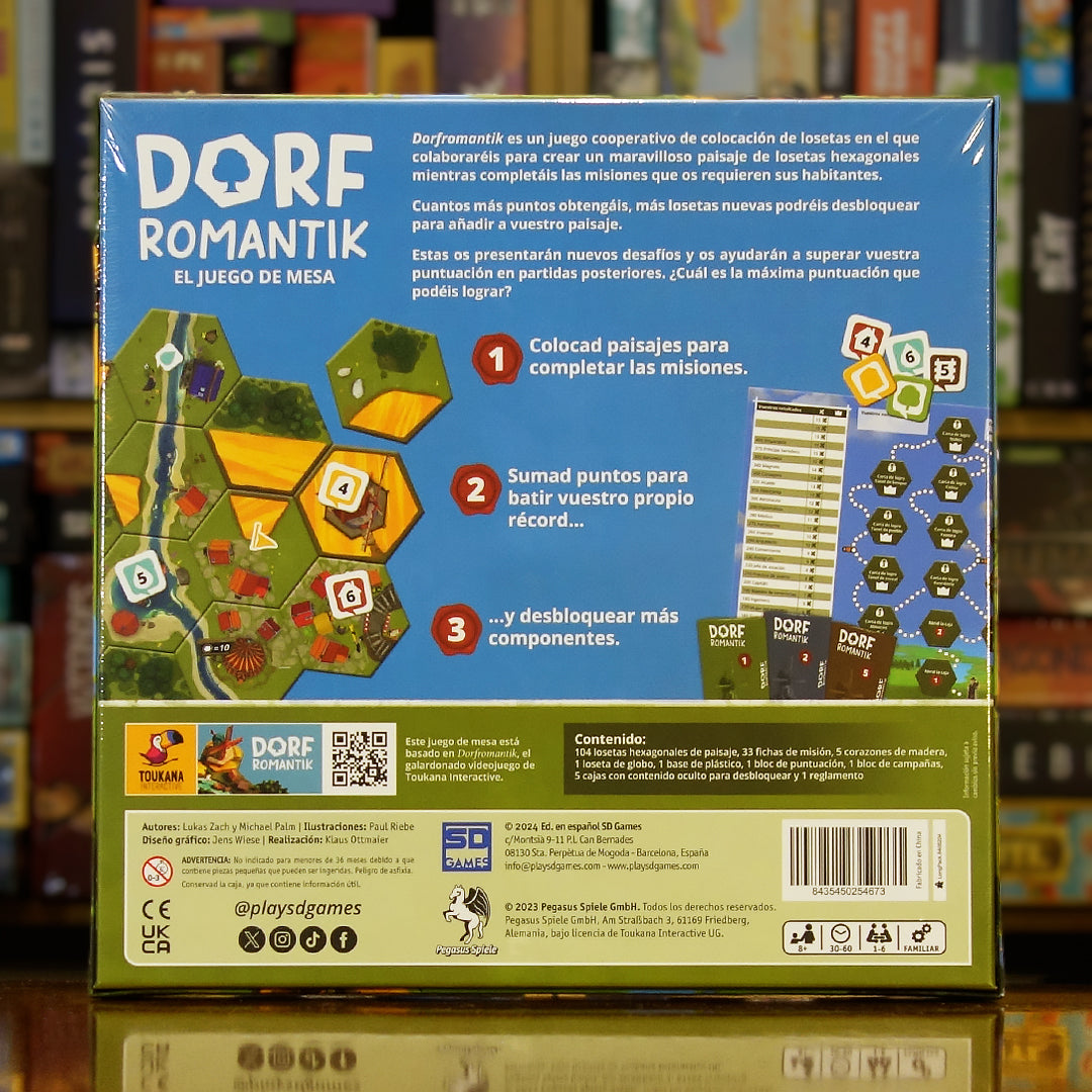 Trasera del juego 'Dorfromantik – El Juego de Mesa' disponible en Mana House – Construcción de paisajes, Campaña rejugable, Fichas ocultas desbloqueables, Hasta 6 jugadores, Inspirado en el éxito indie de Toukana Interactive. Dorfromantik: The Board Game